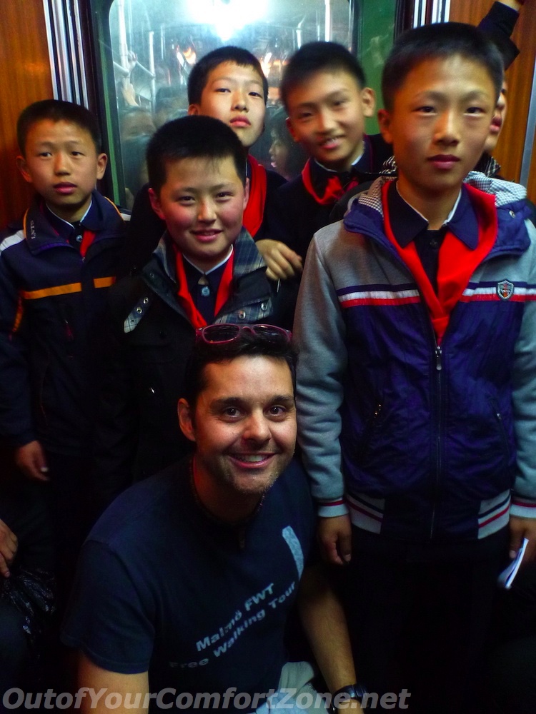 western foreigner with local North Korea schoolchildren Pyongyang in metro