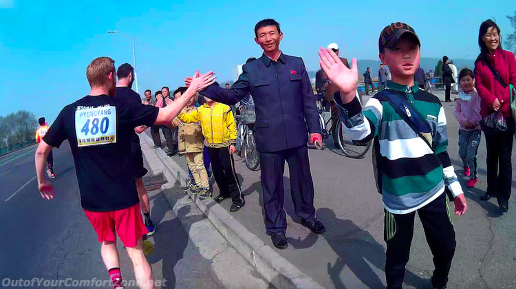 North Koreans giving high five to foreigners