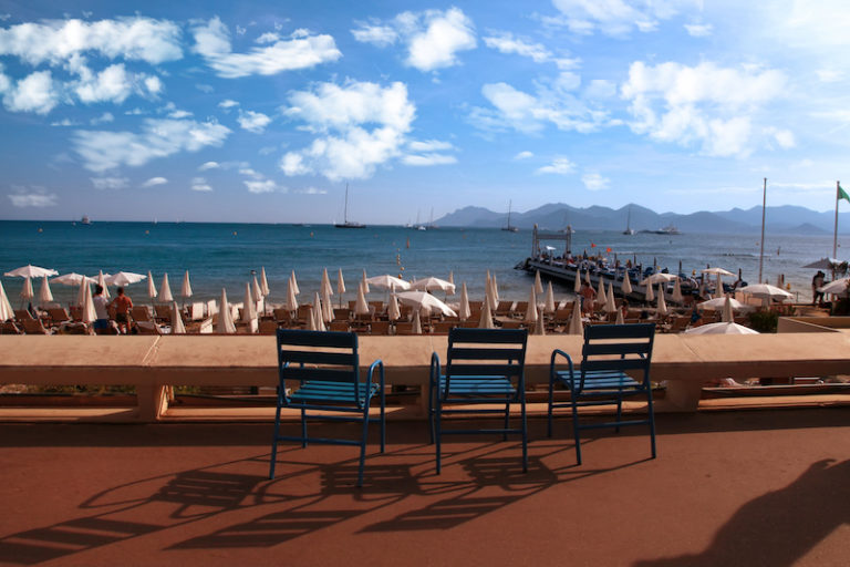 CANNES, FRANCE - JULY 5, 2014. Three chairs for guests on Croisette promenade in Cannes, France. CANNES, FRANCE - JULY 5, 2014