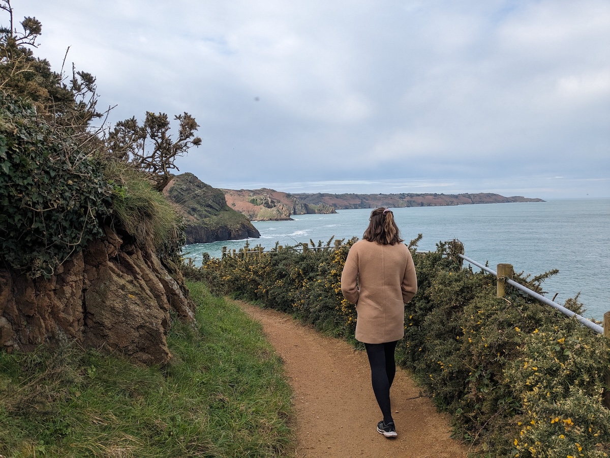 Woman walking by the coast